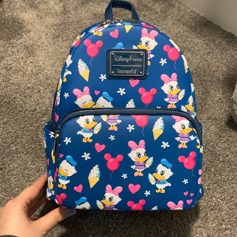 Donald and Daisy lounge fly Disney parks bag